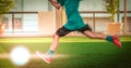 Little boy kicking a soccer ball in sport training session with motion blur and light effect Royalty Free Stock Photo