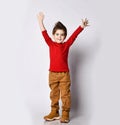 Little boy kid child, stylish hairstyle in sunglasses, red jumper smiling spread hands, pointing fingers showing tongue posing