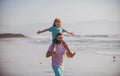 Little boy kid with daddy carrying him on shoulders. Father giving son ride on back outside. Concept of friendly family Royalty Free Stock Photo