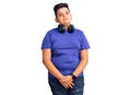 Little boy kid listening to music wearing headphones relaxed with serious expression on face Royalty Free Stock Photo