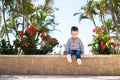 Little boy kid sitting on bench in park Royalty Free Stock Photo