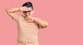 Little boy kid wearing casual clothes and glasses smiling cheerful playing peek a boo with hands showing face Royalty Free Stock Photo