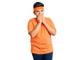 Little boy kid wearing sportswear laughing and embarrassed giggle covering mouth with hands, gossip and scandal concept Royalty Free Stock Photo