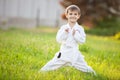 Little boy in kimono standing on grass in park Royalty Free Stock Photo