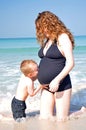 Little boy kissing belly of his pregnant mother Royalty Free Stock Photo