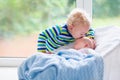 Little boy kissing newborn baby brother Royalty Free Stock Photo
