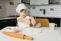 Little boy in kitchen.Cute boy wears a chef hat and apron