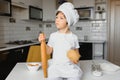 Little boy in kitchen.Cute boy wears a chef hat and apron