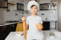 Little boy in kitchen.Cute boy wears a chef hat and apron