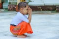 LITTLE BOY KNEELS AND PRAYS AT SHWEDAGON TEMPLE..