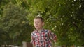 Little boy launches a paper plane.