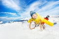 Little boy lay on sledge smile and slide down Royalty Free Stock Photo