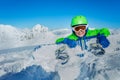 Small boy lay with snowboard in snow over mountain Royalty Free Stock Photo