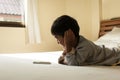 Little boy laying on bed play smart phone Royalty Free Stock Photo