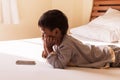 Little boy laying on bed play smart phone Royalty Free Stock Photo