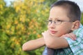 Little boy is lean elbow on bridge fence