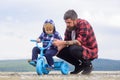 Little boy learn to ride a bike with his daddy. Dad teaching son to ride bicycle. Father teaching his son cycling Royalty Free Stock Photo