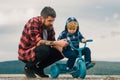 Little boy learn to ride a bike with his daddy. Dad teaching son to ride bicycle. Father teaching his son cycling Royalty Free Stock Photo