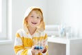 Little boy is learning carefully brush teeth. Child using liquid for disclosing plaque. Teaching children proper oral hygiene.