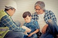 Little boy learning from his construction Multi generation family