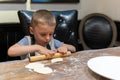 Little boy learning how to make dumplings Royalty Free Stock Photo