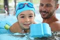 Little boy learning how to swim with instructor Royalty Free Stock Photo