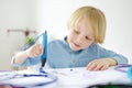 Little boy learning make model with 3d printing pen. Child playing with new modern toy for creativity. DIY. STEM and STEAM Royalty Free Stock Photo