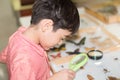 Little boy learning science class with microscope in the class Royalty Free Stock Photo