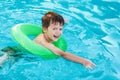 Little boy learning swim with saver