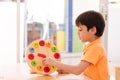 Little boy learning time with clock toy of montessori educationa