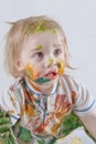 The little boy is learning to draw. He smeared his face, arms, legs and clothes with paint Royalty Free Stock Photo