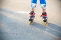 Little boy learning to roller skate in summer park. Children wearing protection pads for safe roller skating ride. Active outdoor Royalty Free Stock Photo