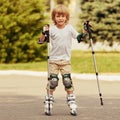 Cute Boy learning rollerblading Royalty Free Stock Photo