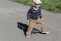 A little boy learns extreme sports, skateboarding in the summer on the playground, in the park and outdoors