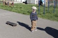 A little boy learns extreme sports, skateboarding in the summer on the playground, in the park and outdoors