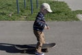 A little boy learns extreme sports, skateboarding in the summer on the playground, in the park and outdoors