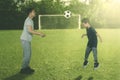 Little boy learns to heading a ball with his father Royalty Free Stock Photo