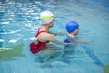 Little boy learns to swim in an individual lesson with a trainer Royalty Free Stock Photo