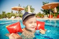 A little boy learns to swim in the pool in the summer with the support of his father`s hands Royalty Free Stock Photo