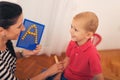 Little boy during lesson with his speech therapist. Royalty Free Stock Photo