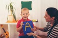 Little boy during lesson with his speech therapist. Royalty Free Stock Photo