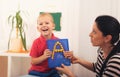 Little boy during lesson with his speech therapist. Royalty Free Stock Photo