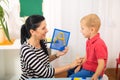 Little boy during lesson with his speech therapist. Royalty Free Stock Photo