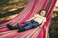 Little boy lies in a colored hammock. Royalty Free Stock Photo