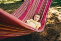 Little boy lies in a colored hammock. Royalty Free Stock Photo