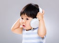 Little boy listen to the music and holding the headset