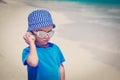 Little boy listening seashell at the beach Royalty Free Stock Photo