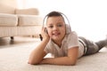 Little boy listening to music on floor Royalty Free Stock Photo