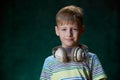 Little boy listens to his favorite music in modern wireless headphones, in the studio Royalty Free Stock Photo