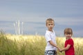 Little boy and little girl holding hands looking very displeased Royalty Free Stock Photo